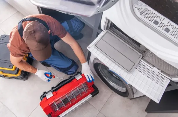 Técnico está en una casa realizando un servicio de reparación de lavadora Maytag porque tuvo un problema en el motor